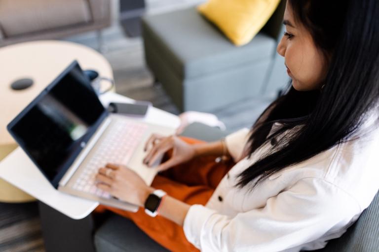 woman types on laptop