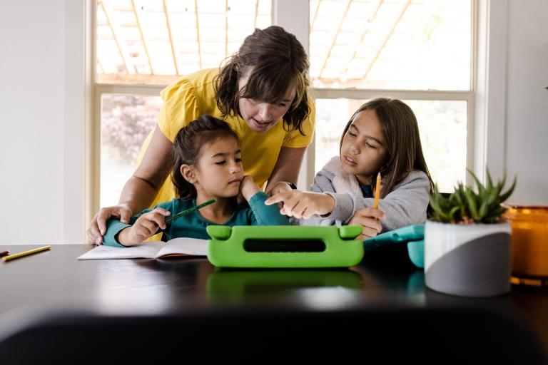 Parent helping children with homework